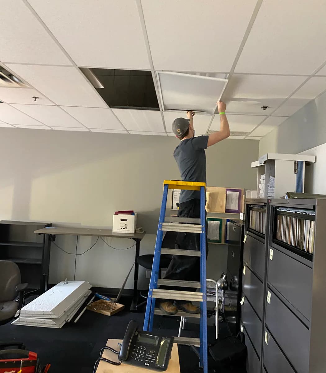 PTX team member servicing commercial ceiling lighting