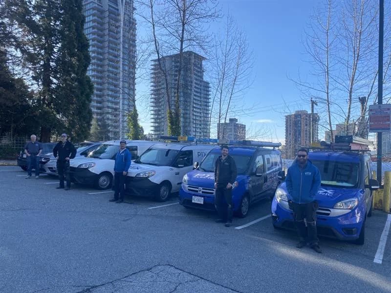 PTX Electric team with branded service vehicles in Burnaby