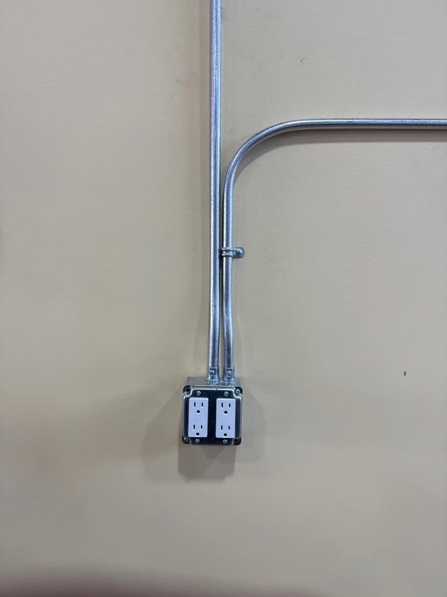 New EMT conduit and receptacle box installed after fire damage