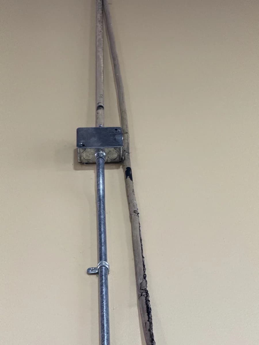 New junction box and conduit beside the existing pathway